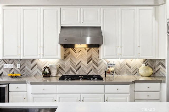 kitchen featuring extractor fan, white cabinetry, and decorative backsplash