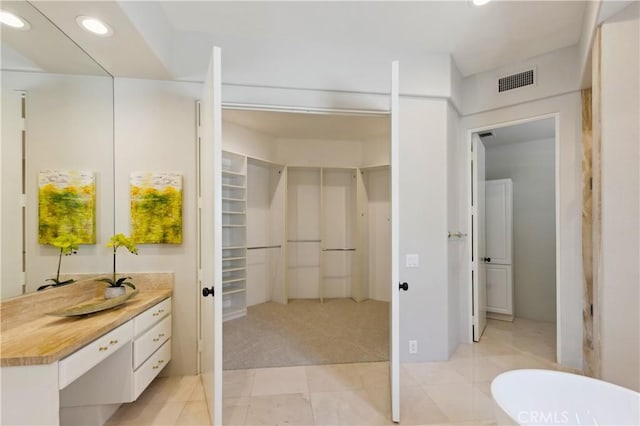 bathroom with tile patterned flooring and vanity