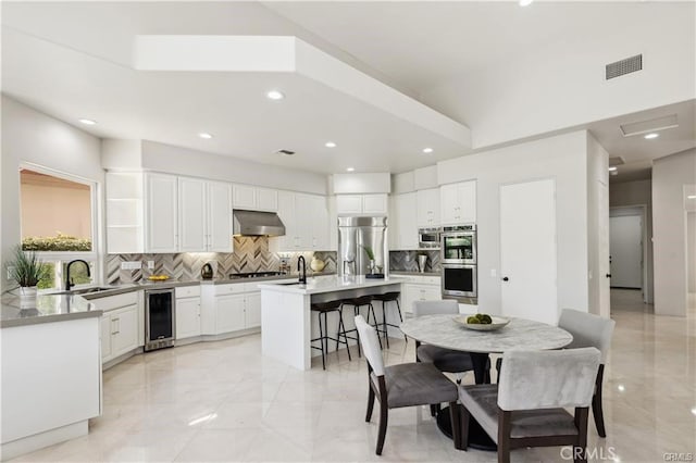 dining area with sink and wine cooler