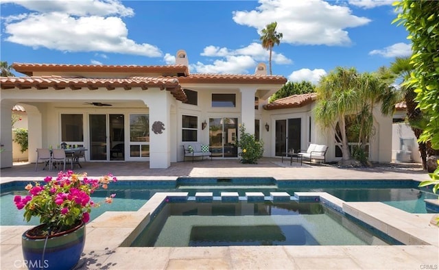 back of house featuring a pool with hot tub, a patio area, and ceiling fan