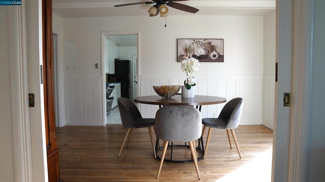 dining space with hardwood / wood-style flooring and ceiling fan