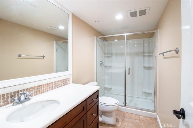 bathroom with vanity, tile patterned floors, decorative backsplash, toilet, and an enclosed shower