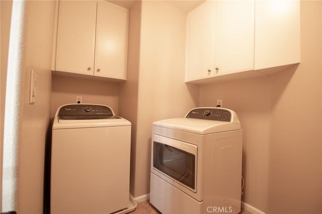 laundry room with cabinets and separate washer and dryer