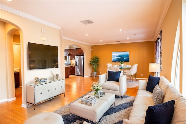 living room featuring light hardwood / wood-style floors and ornamental molding