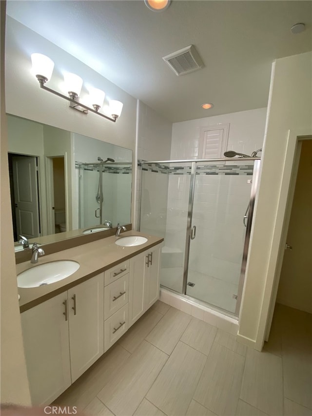 bathroom with vanity, toilet, and an enclosed shower