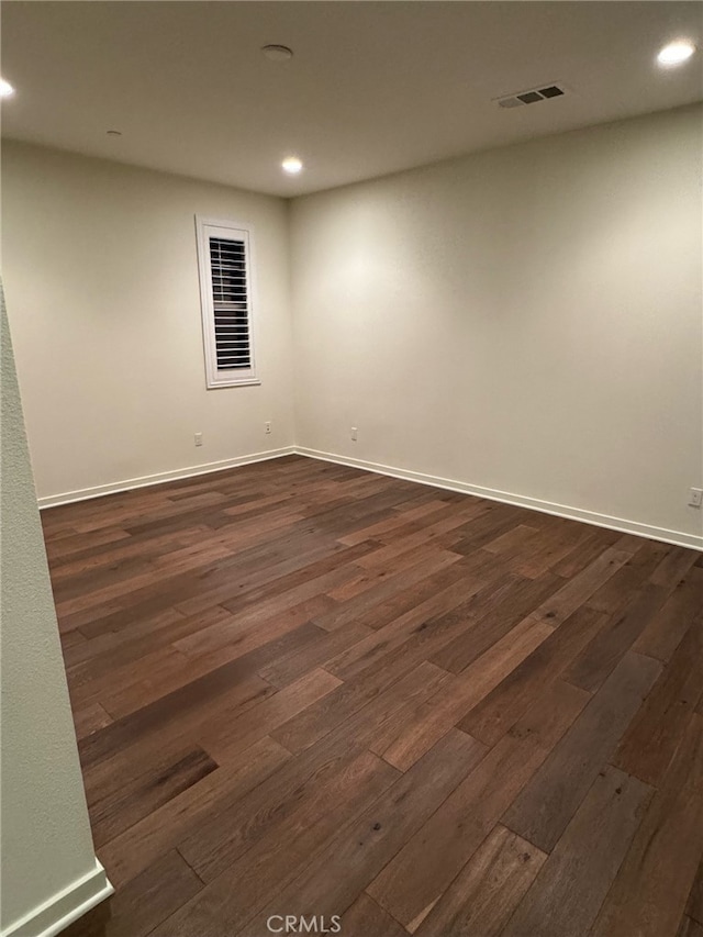 unfurnished room featuring dark hardwood / wood-style floors