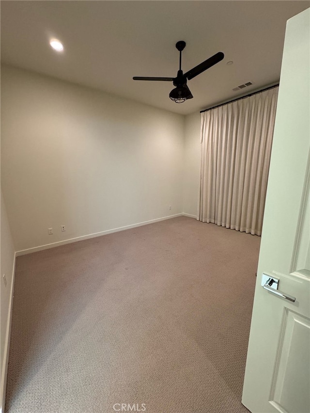 empty room featuring light carpet and ceiling fan