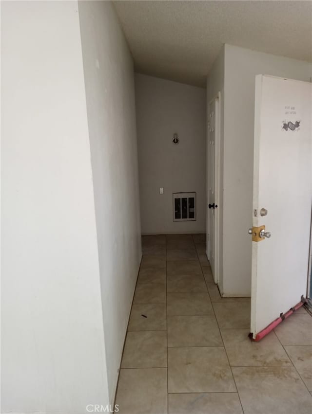 corridor featuring light tile patterned floors