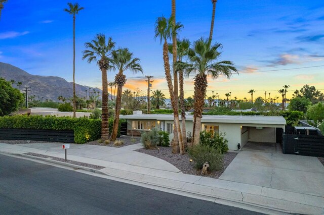 view of front of home with a mountain view and a carport