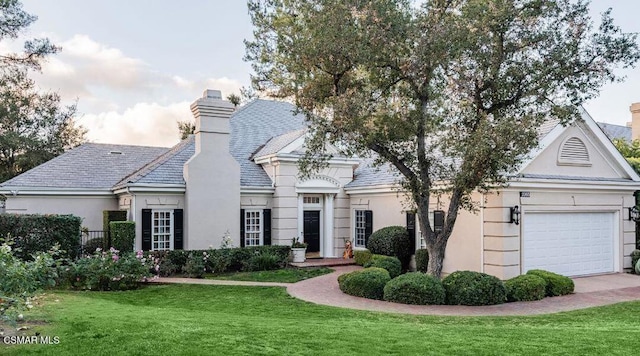 view of front facade with a front lawn and a garage