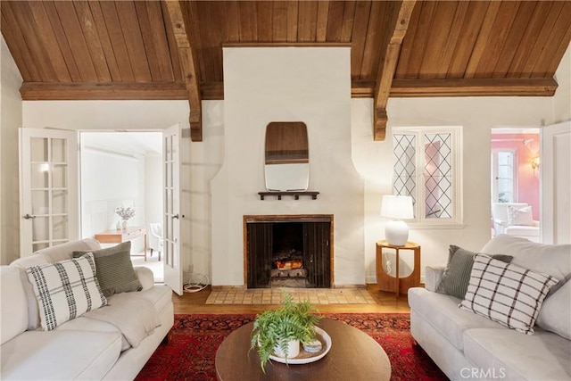 living room with wood ceiling and beamed ceiling