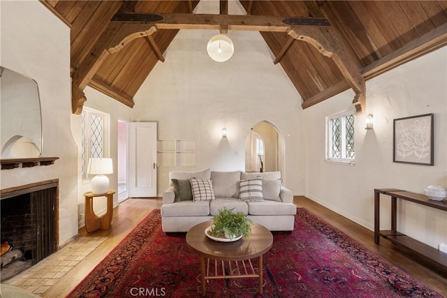 living room featuring wood-type flooring, wooden ceiling, and beamed ceiling