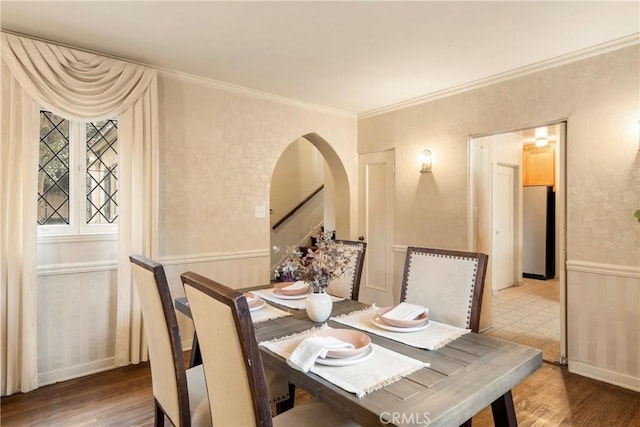 dining space featuring crown molding and hardwood / wood-style floors