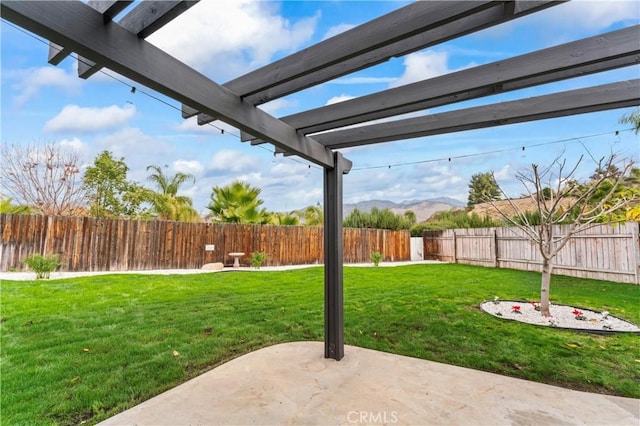 view of yard featuring a mountain view and a patio area