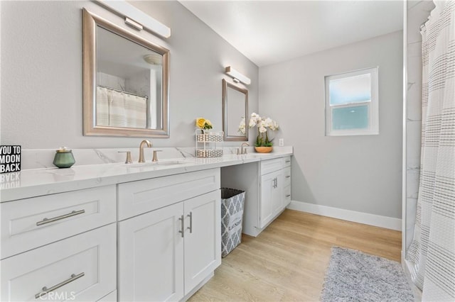 bathroom featuring hardwood / wood-style flooring and vanity