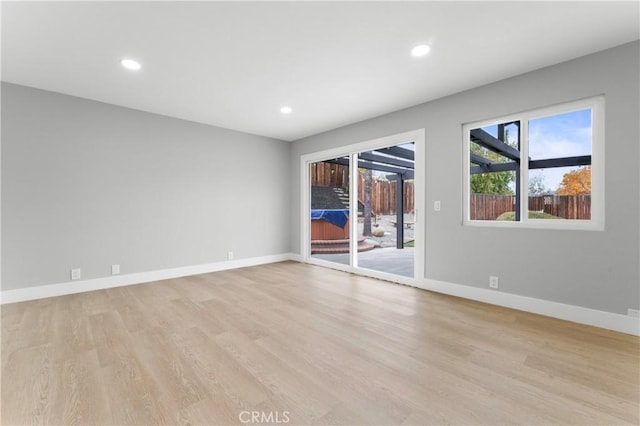 empty room with light hardwood / wood-style flooring