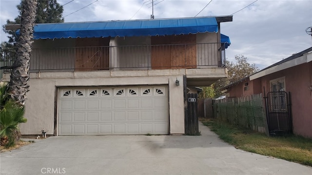 view of front of home with a balcony and a garage