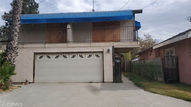 view of front of house with a garage and a balcony