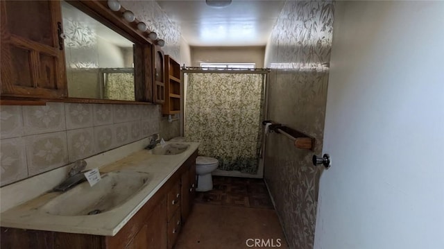 bathroom with tasteful backsplash, vanity, tile walls, and toilet