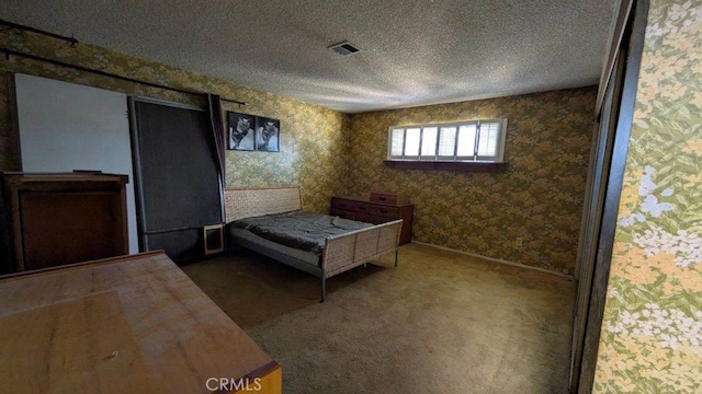 unfurnished bedroom with a textured ceiling and carpet flooring