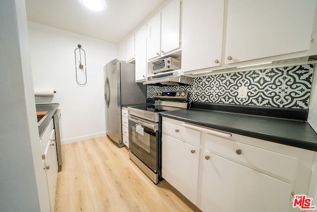 kitchen with tasteful backsplash, white cabinetry, light hardwood / wood-style flooring, and appliances with stainless steel finishes