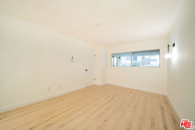 unfurnished room with light hardwood / wood-style flooring