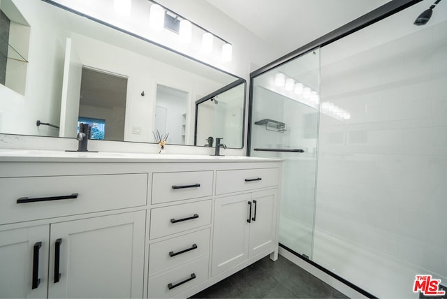 bathroom with vanity and a shower with shower door