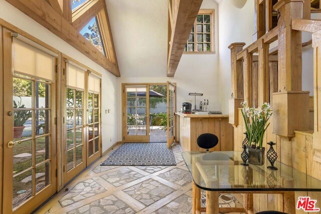 interior space featuring high vaulted ceiling and french doors