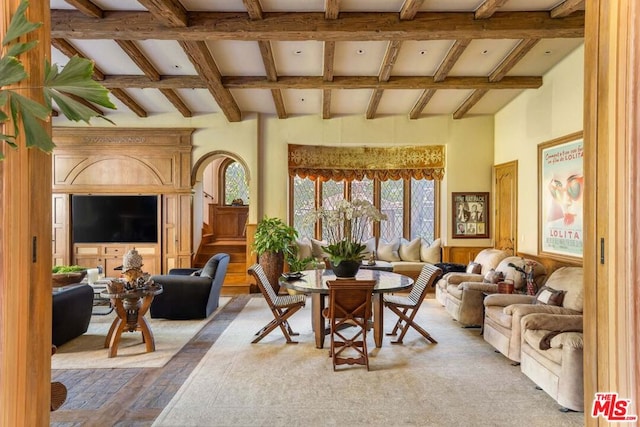 living room featuring beamed ceiling