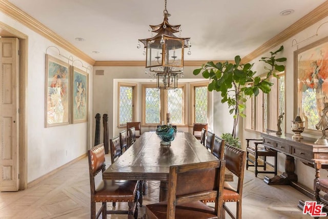 dining area with crown molding, a chandelier, and light parquet floors