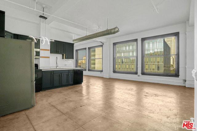 kitchen with appliances with stainless steel finishes, sink, and decorative light fixtures