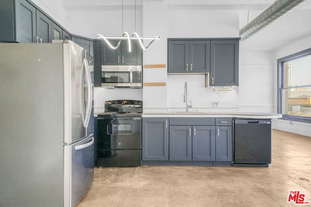 kitchen featuring black appliances, decorative light fixtures, and sink