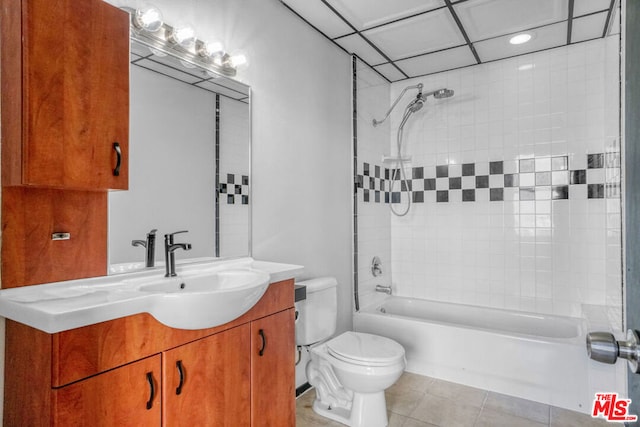 full bathroom featuring tile patterned floors, vanity, toilet, and tiled shower / bath combo