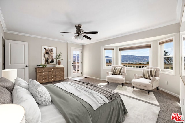 bedroom featuring a mountain view, access to outside, crown molding, ceiling fan, and carpet floors