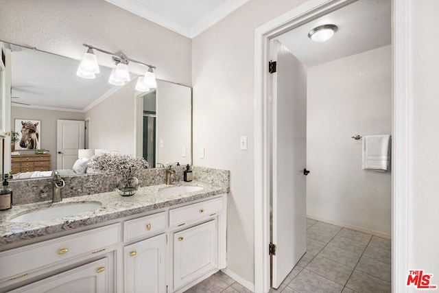 bathroom with tile patterned flooring, vanity, ceiling fan, and ornamental molding