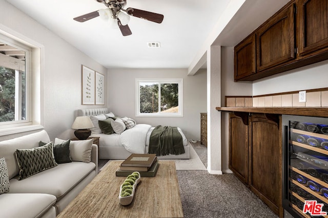 carpeted bedroom featuring wine cooler and ceiling fan