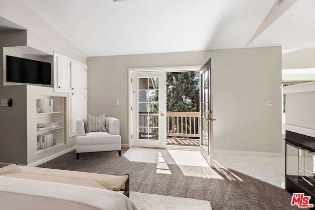 living room featuring a multi sided fireplace, light colored carpet, and vaulted ceiling