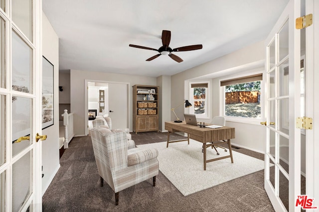 office space featuring french doors, dark carpet, and ceiling fan