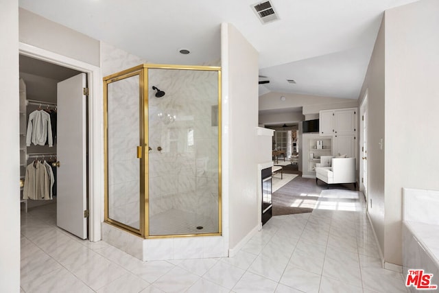 bathroom featuring lofted ceiling and walk in shower