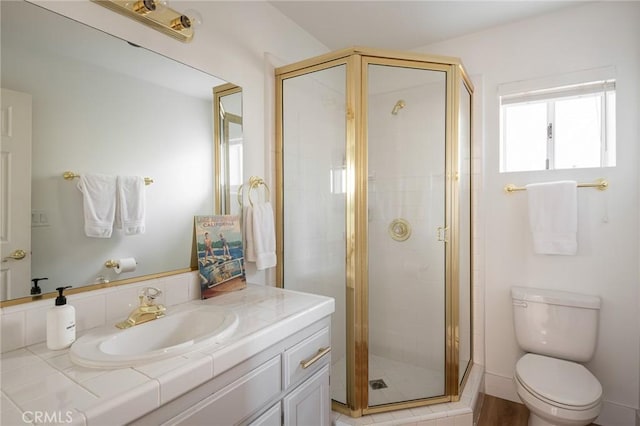 bathroom featuring vanity, toilet, and walk in shower