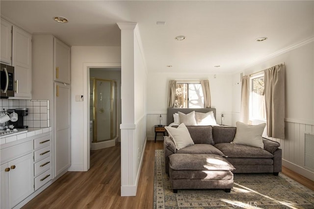 living room with hardwood / wood-style floors and ornamental molding