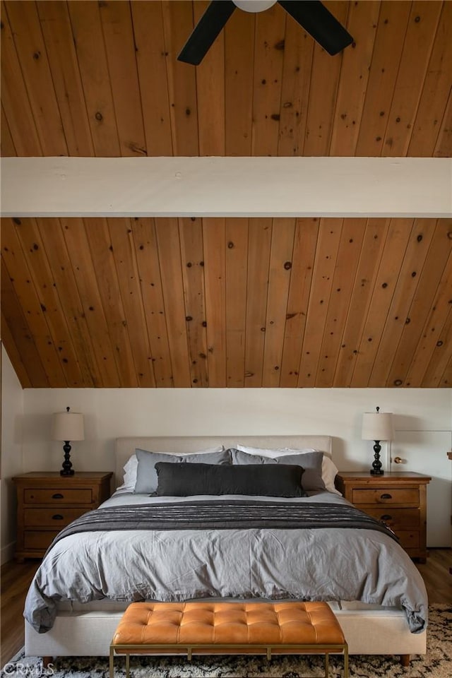 bedroom with wood-type flooring, ceiling fan, lofted ceiling, and wood walls