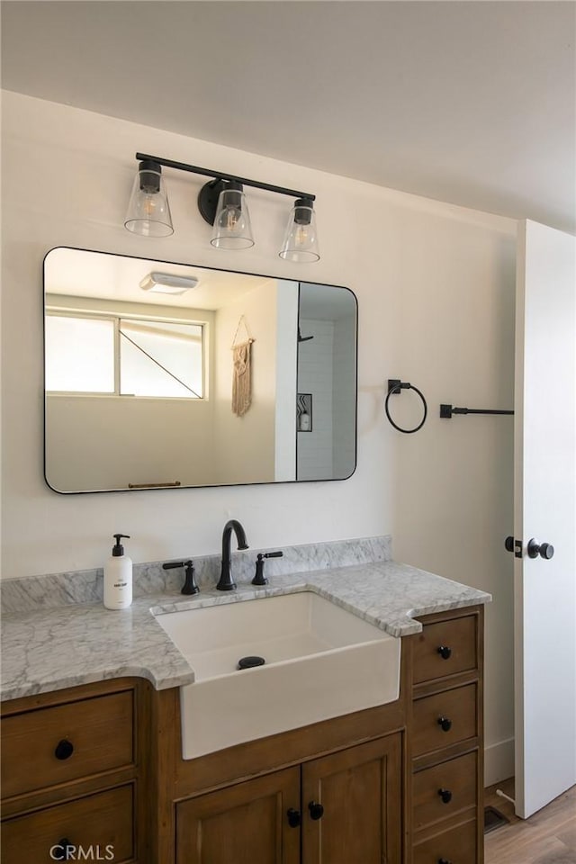 bathroom featuring hardwood / wood-style floors and vanity