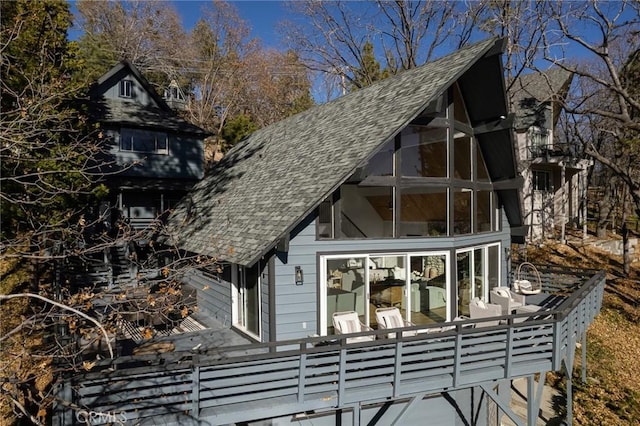 view of home's exterior with a wooden deck