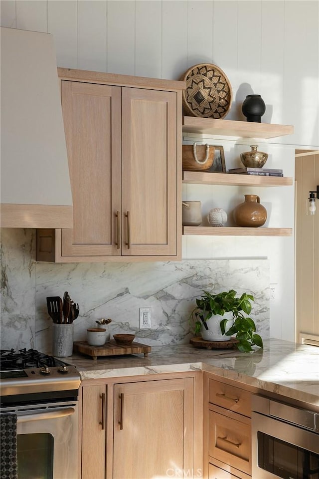 kitchen with appliances with stainless steel finishes, backsplash, and light brown cabinetry