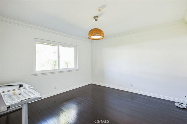 spare room with dark hardwood / wood-style floors and ornamental molding