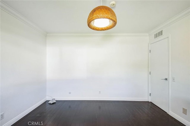 spare room featuring dark wood-type flooring and ornamental molding