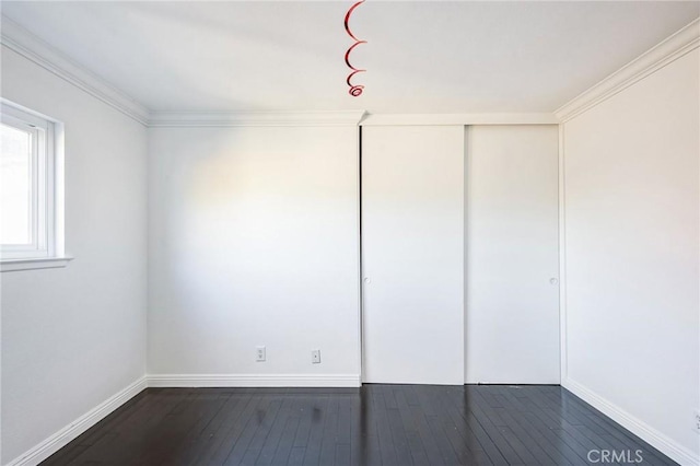 spare room with dark hardwood / wood-style flooring and ornamental molding