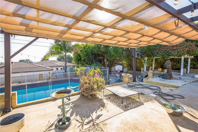 view of patio featuring a fenced in pool and a pergola