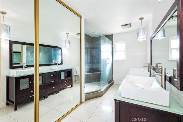 bathroom with tile patterned floors, vanity, and a shower with shower door